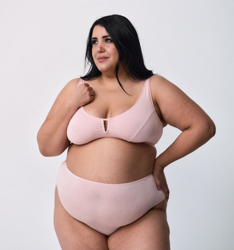 customer wearing belle maternity bra in shield, baby snuggling lying down