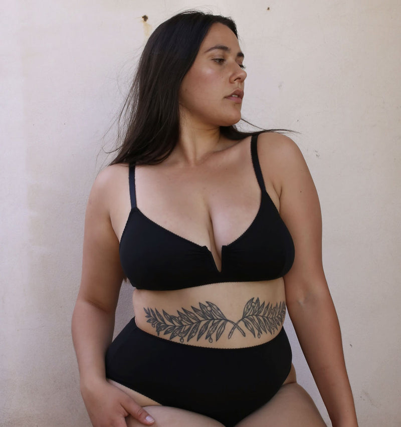 customer wearing Belle in rosy, lying down, baby snuggling with mum, breastfeeding.